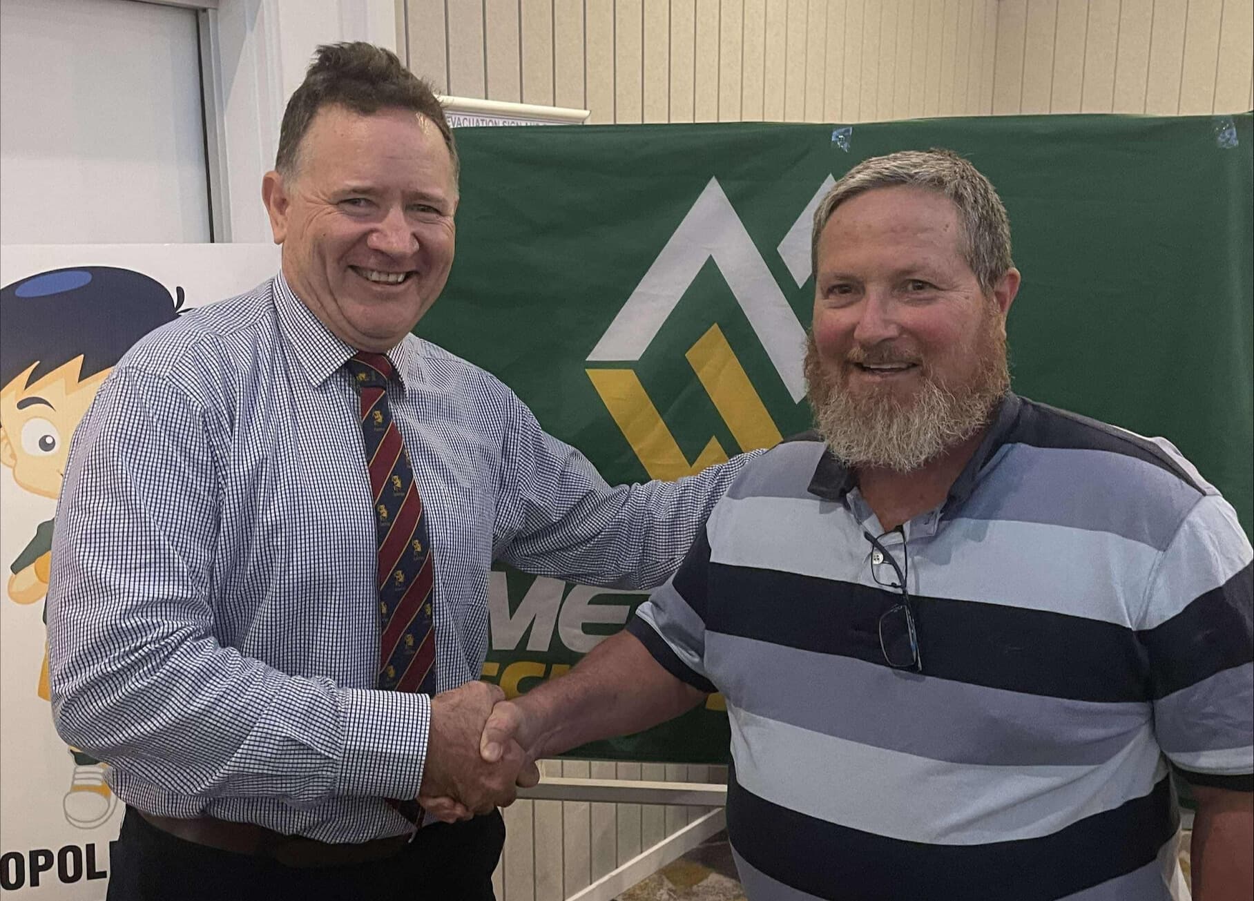 Darren Kayrooz (right) being congratulated earlier this year on his Life Membership for Met West School Sport by John Brew